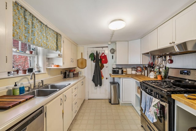 57 Oxford St, Augusta, ME 04330 - kitchen with white cabinets, a sink, stainless steel appliances, light floors, and under cabinet range hood