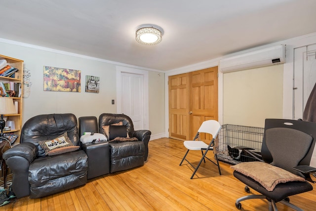 57 Oxford St, Augusta, ME 04330 - living area featuring crown molding, a wall mounted AC, and light wood-style flooring