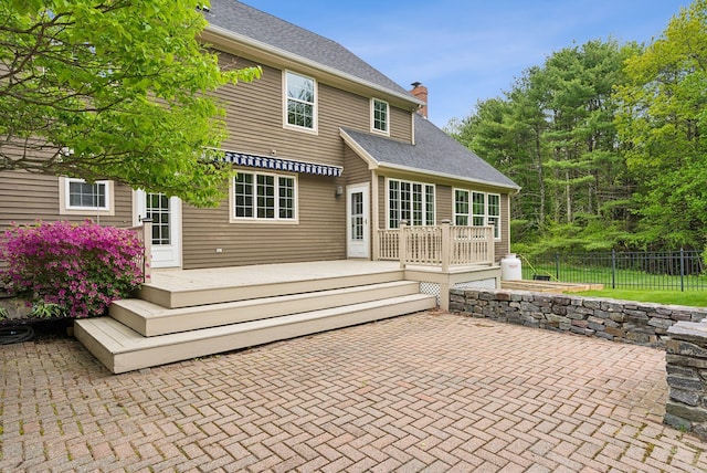 31 Green Trees Dr, Gorham, ME 04038 - rear view of house with a patio area, a wooden deck, a chimney, and a shingled roof