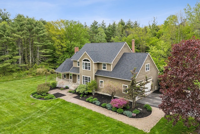 31 Green Trees Dr, Gorham, ME 04038 - view of front of property featuring a porch, driveway, a chimney, a front lawn, and roof with shingles