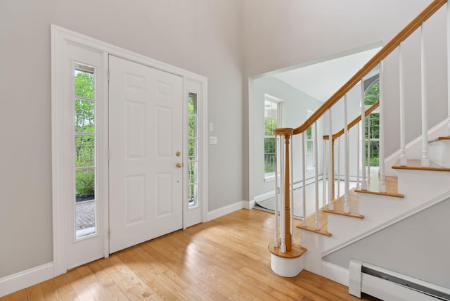 31 Green Trees Dr, Gorham, ME 04038 - foyer with a baseboard radiator, wood finished floors, stairway, baseboards, and a high ceiling