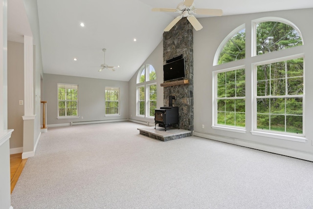31 Green Trees Dr, Gorham, ME 04038 - unfurnished living room with a ceiling fan, baseboard heating, a wood stove, high vaulted ceiling, and carpet