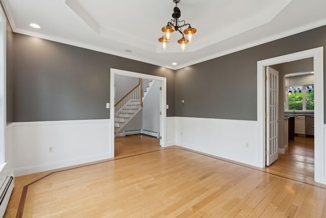 31 Green Trees Dr, Gorham, ME 04038 - spare room with a chandelier, light wood-style floors, stairway, a tray ceiling, and ornamental molding