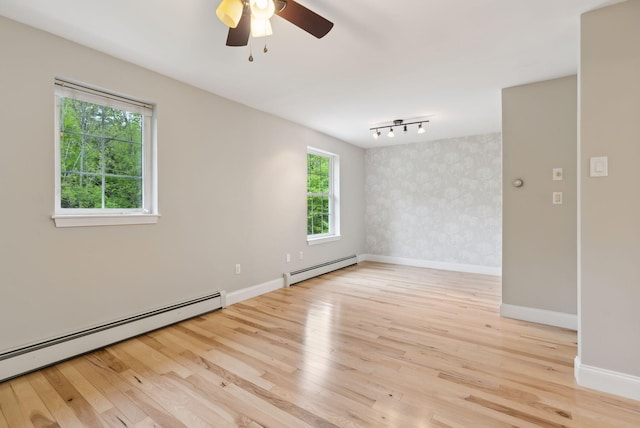 31 Green Trees Dr, Gorham, ME 04038 - empty room featuring baseboard heating, light wood-style floors, baseboards, and ceiling fan