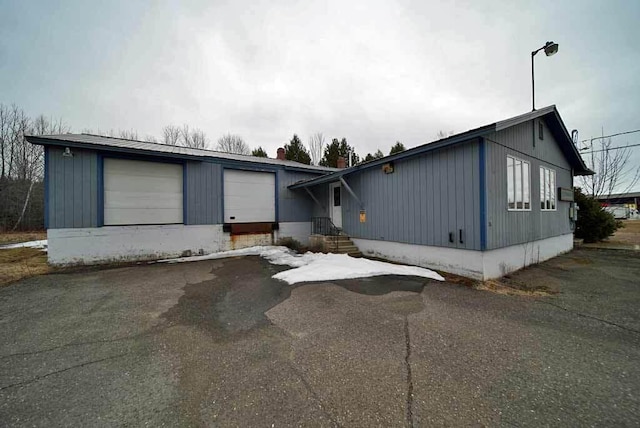 48 Customs Loop, Houlton, ME 04730 - view of front facade with driveway and a garage