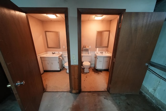48 Customs Loop, Houlton, ME 04730 - bathroom featuring two vanities, toilet, a sink, and concrete flooring