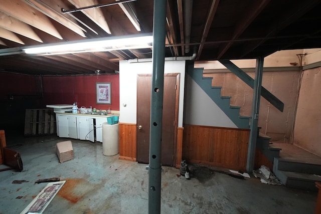 48 Customs Loop, Houlton, ME 04730 - basement with a sink, wooden walls, stairway, and wainscoting