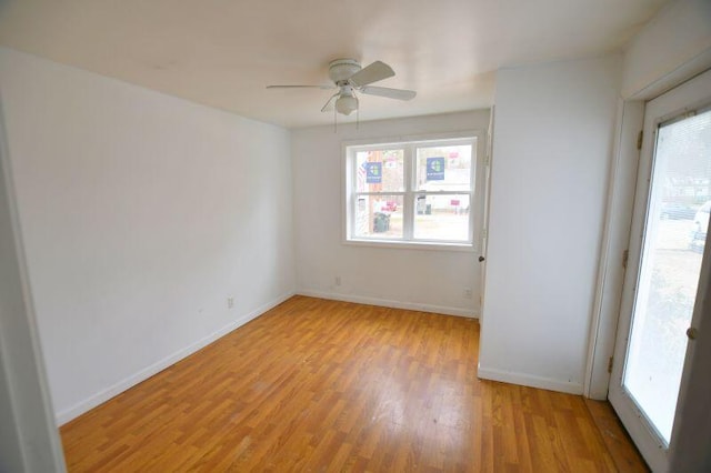 unfurnished room with light wood-style flooring, a ceiling fan, and a healthy amount of sunlight