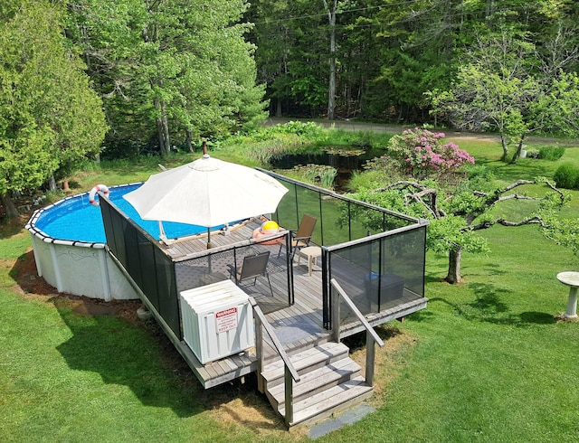 1145 Meadow Pond Rd, Islesboro, ME 04848 - outdoor pool featuring a wooden deck, a yard, and a wooded view