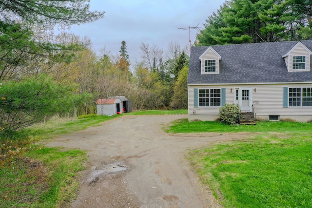 452 Moosehead Trl, Waldo, ME 04915 - view of front of property featuring driveway, a shed, entry steps, an outdoor structure, and roof with shingles