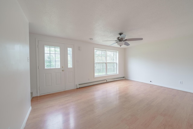 452 Moosehead Trl, Waldo, ME 04915 - entryway featuring a baseboard heating unit, light wood-style floors, a textured ceiling, a ceiling fan, and baseboards