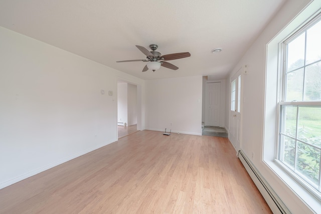 452 Moosehead Trl, Waldo, ME 04915 - empty room featuring a baseboard heating unit, light wood-type flooring, ceiling fan, and baseboards
