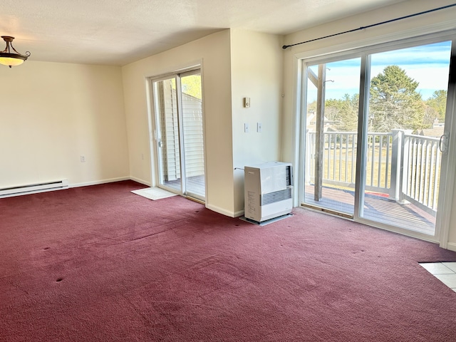 spare room featuring heating unit, carpet flooring, and a healthy amount of sunlight
