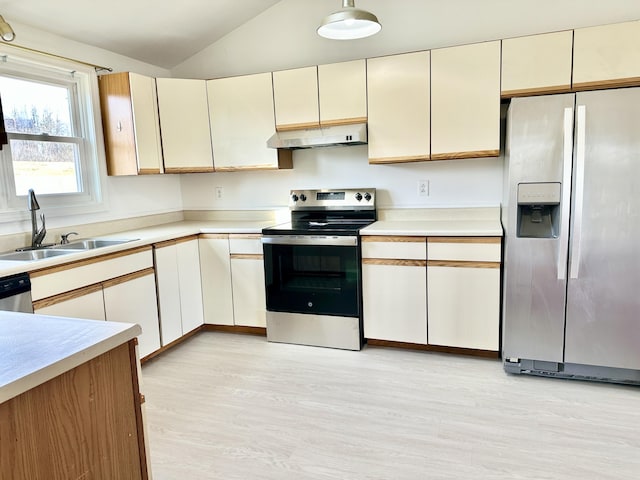 kitchen featuring light countertops, a sink, lofted ceiling, under cabinet range hood, and stainless steel appliances