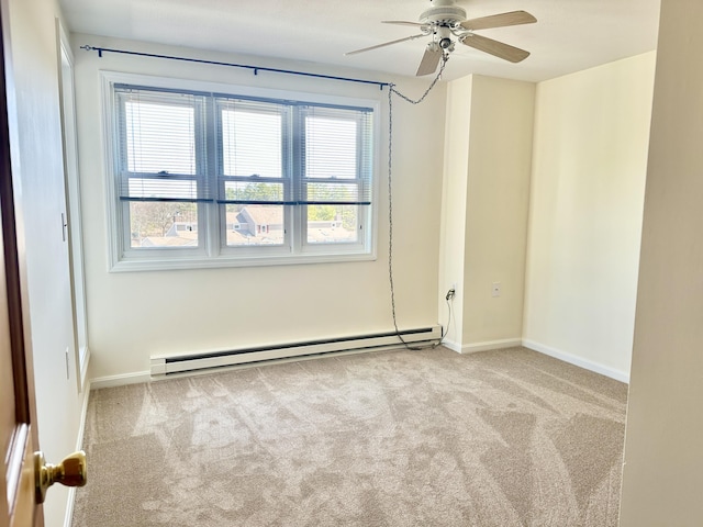 spare room with a ceiling fan, carpet, baseboards, and baseboard heating