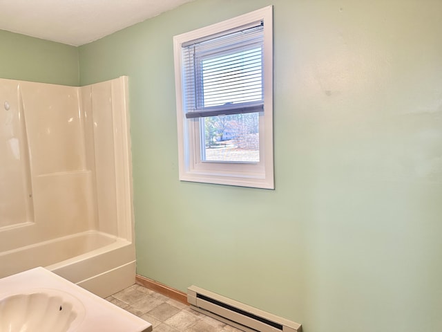 bathroom with baseboards, tile patterned flooring, baseboard heating, and shower / bathtub combination