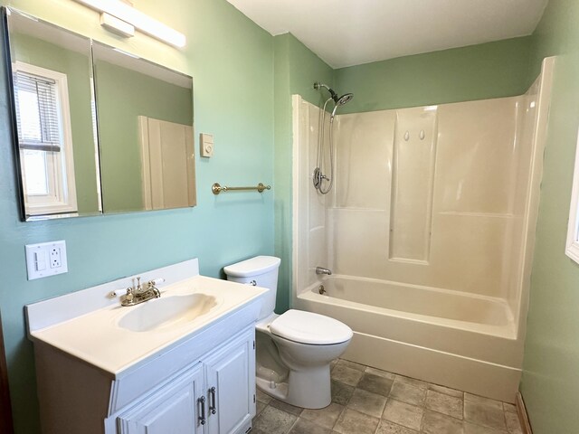 full bath featuring toilet, vanity, and shower / tub combination