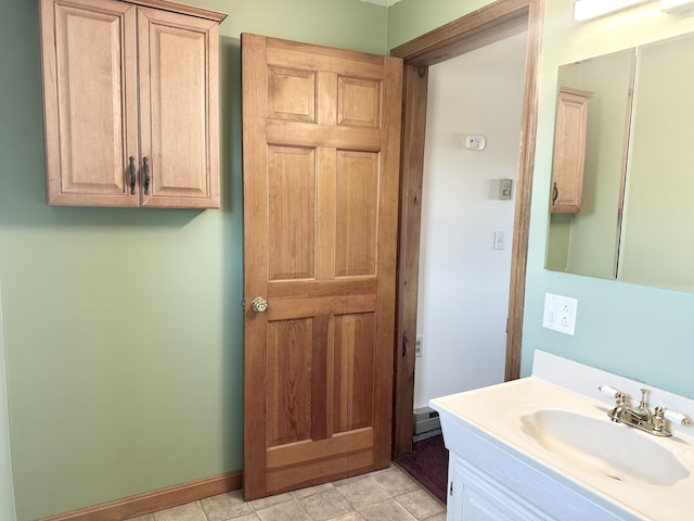 bathroom featuring vanity, baseboards, and a baseboard heating unit