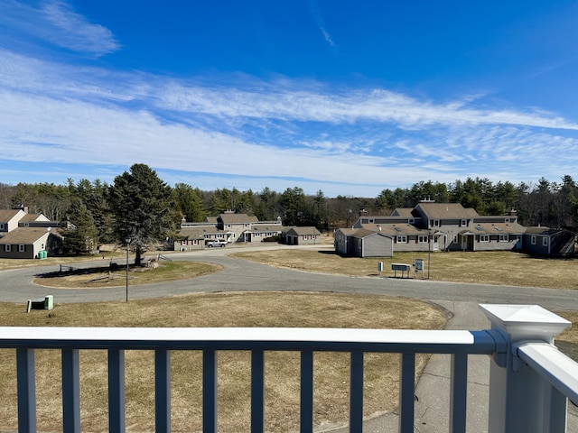 view of yard with a balcony and a residential view
