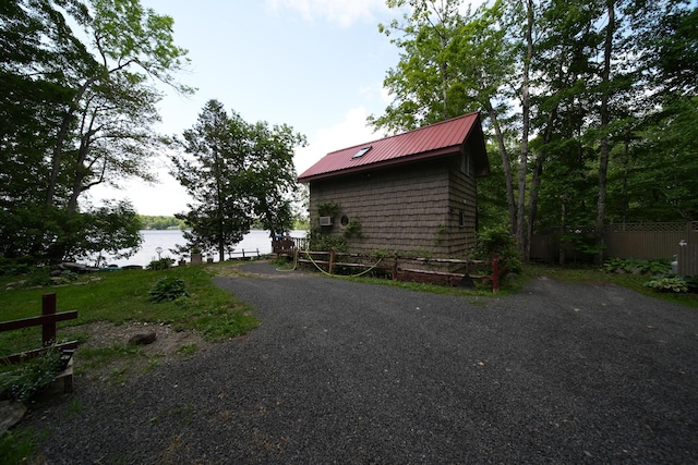 92 Spaulding Lake Rd, Oakfield, ME 04763 - view of home's exterior featuring a water view and a metal roof