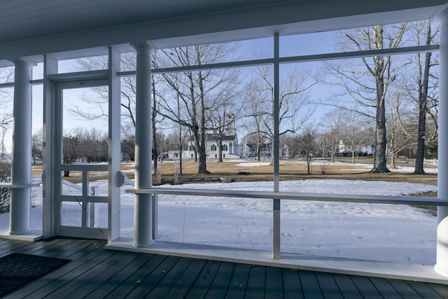 doorway to outside featuring dark wood-style floors and a wall of windows