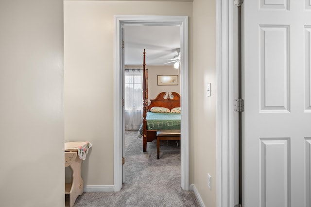 corridor featuring carpet and baseboards