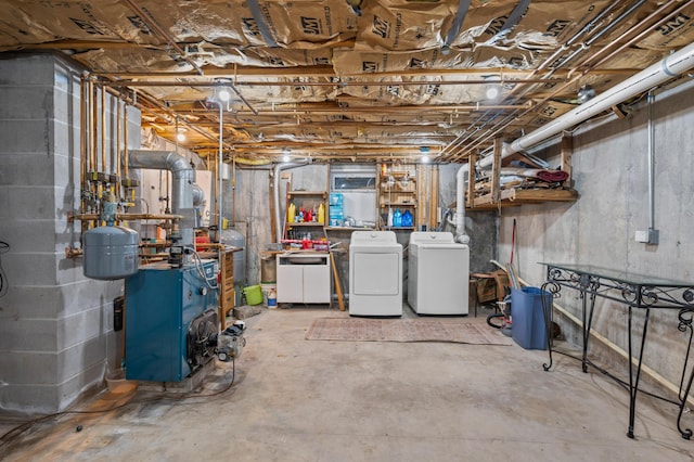 unfinished below grade area featuring washing machine and clothes dryer and a heating unit
