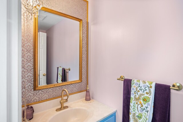 bathroom featuring wallpapered walls and vanity