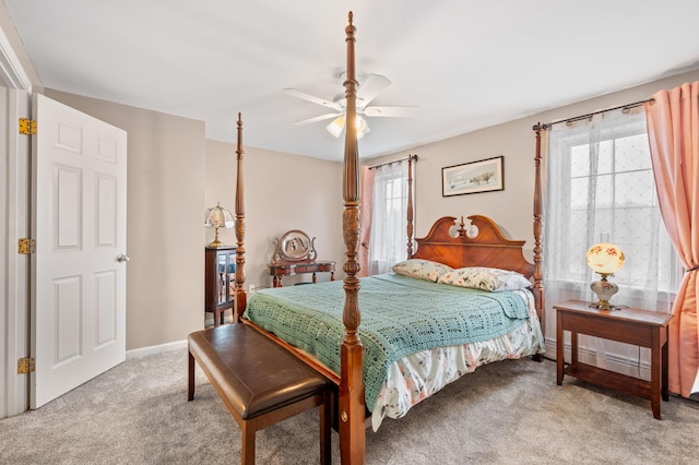 bedroom featuring light carpet, baseboards, and ceiling fan
