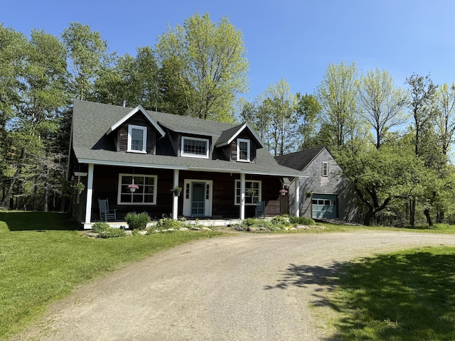 148 Pendleton Point Rd, Islesboro, ME 04848 - view of front of property featuring covered porch, a garage, driveway, and a front lawn