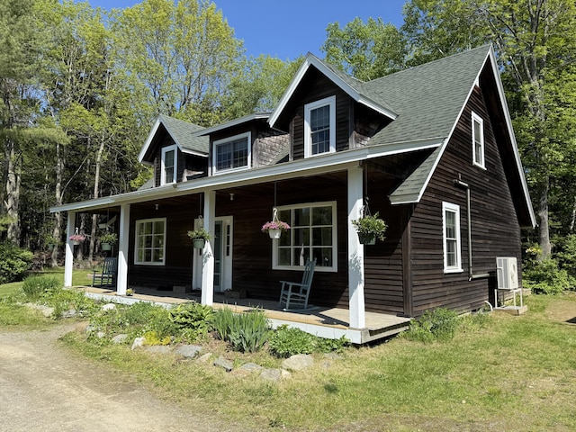 148 Pendleton Point Rd, Islesboro, ME 04848 - view of front of home with covered porch, roof with shingles, and a front yard