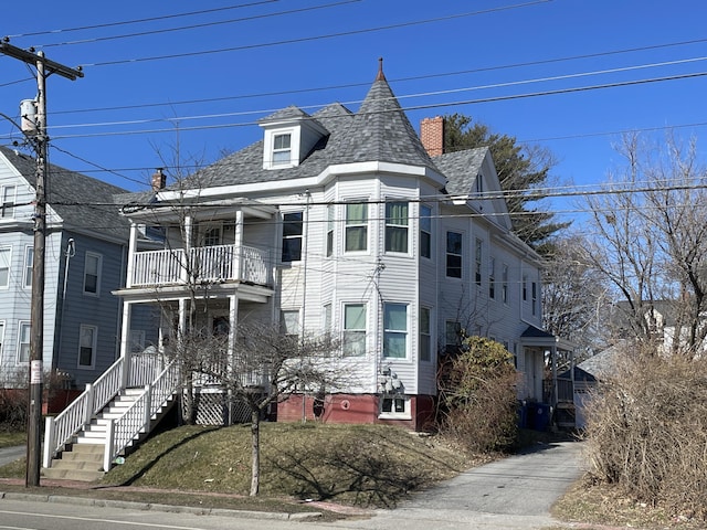 613 Washington Ave, Portland, ME 04103 - victorian-style house featuring a shingled roof, a chimney, and a balcony