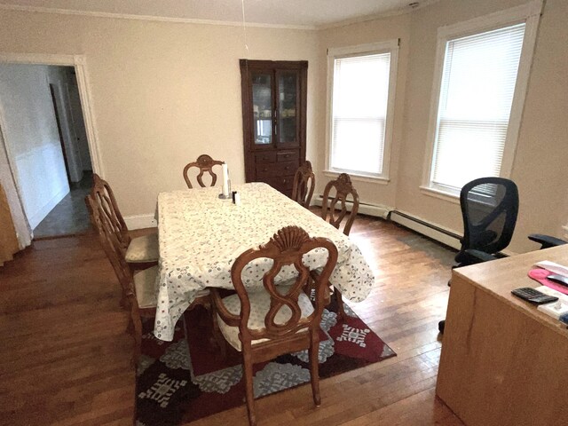613 Washington Ave, Portland, ME 04103 - dining room with baseboards, ornamental molding, baseboard heating, and wood finished floors