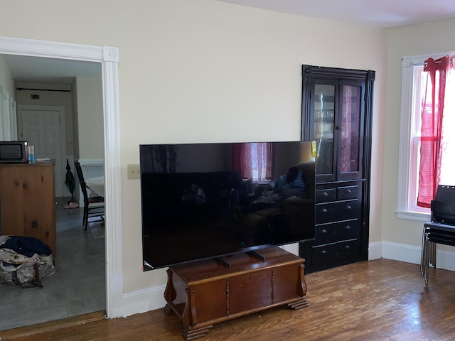 613 Washington Ave, Portland, ME 04103 - interior details featuring baseboards, wood finished floors, and black microwave