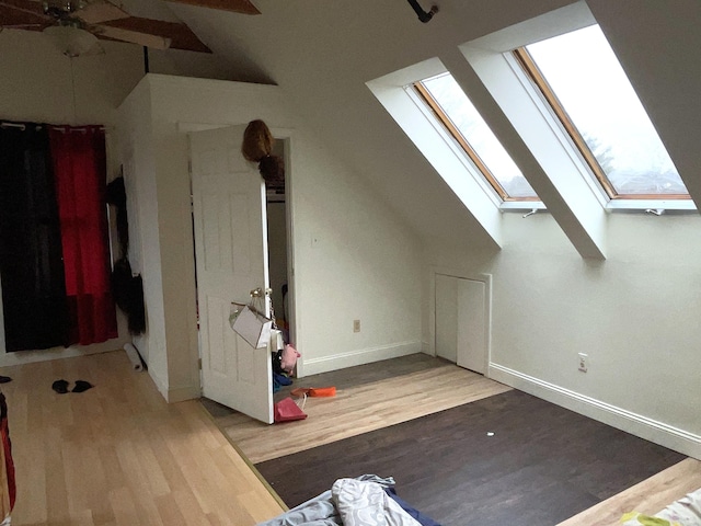 613 Washington Ave, Portland, ME 04103 - additional living space with a ceiling fan, baseboards, wood finished floors, and lofted ceiling with skylight