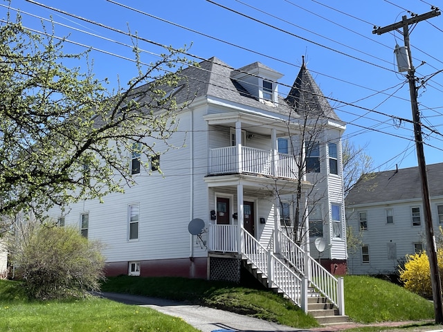 613 Washington Ave, Portland, ME 04103 - view of front facade featuring a balcony, roof with shingles, and a front lawn
