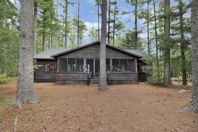 back of house featuring a sunroom