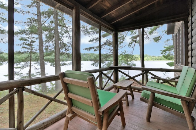 sunroom / solarium featuring a water view and healthy amount of natural light