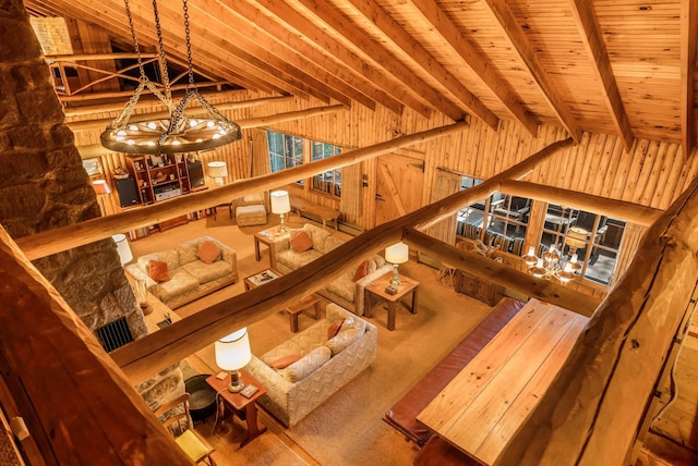 living area with a chandelier, lofted ceiling, and wood ceiling