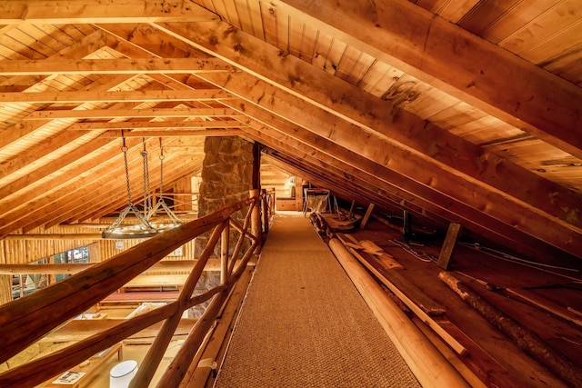 unfinished attic featuring an upstairs landing