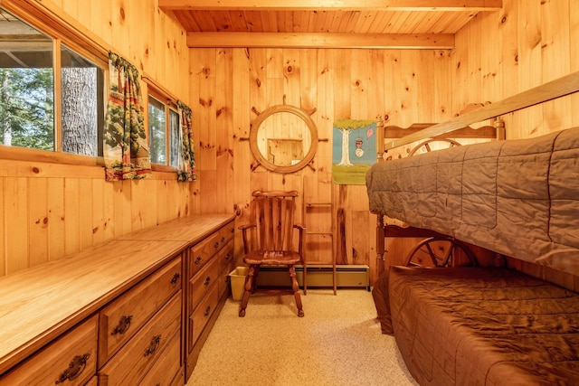 bedroom with wooden ceiling, wood walls, a baseboard heating unit, and beamed ceiling