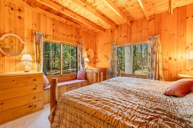 carpeted bedroom featuring beam ceiling, wooden walls, and wood ceiling