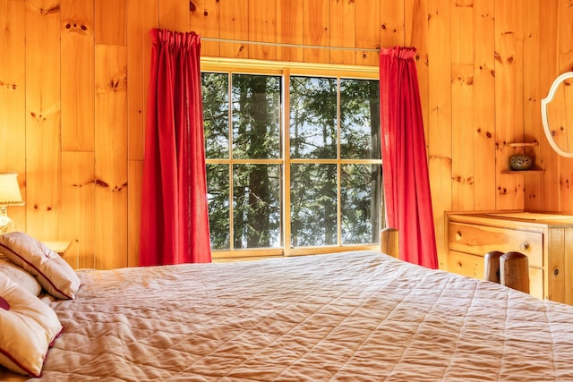 bedroom with wood walls