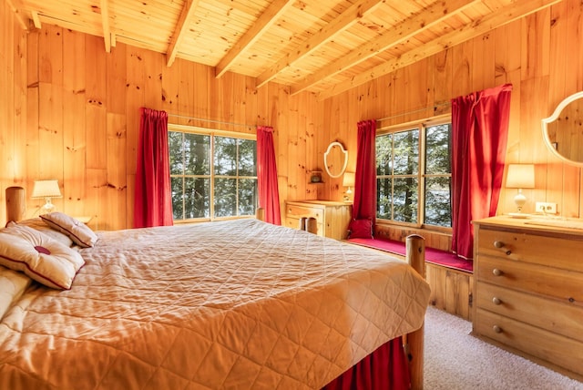carpeted bedroom featuring wooden walls, multiple windows, beamed ceiling, and wooden ceiling