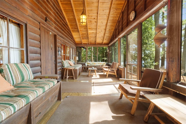 sunroom featuring wood ceiling, healthy amount of natural light, lofted ceiling, and rustic walls