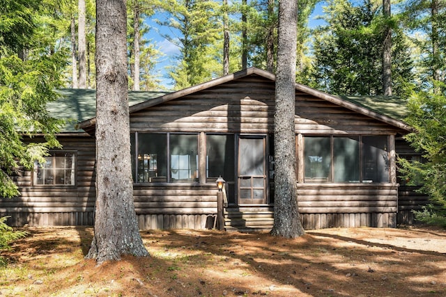 view of property exterior featuring a sunroom