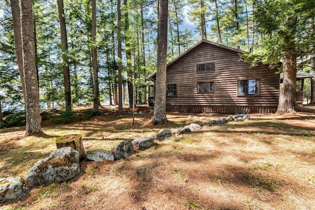 view of side of property featuring log veneer siding