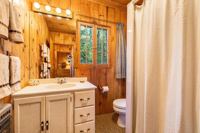 full bathroom with wooden walls, toilet, vanity, wooden ceiling, and curtained shower