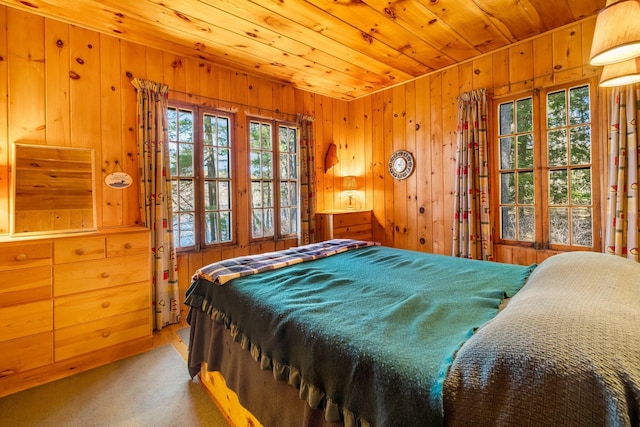 bedroom with wood walls and wood ceiling