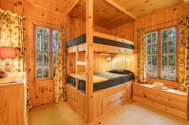 bedroom with carpet floors, wood walls, multiple windows, and wood ceiling